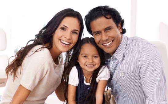 man, woman, and child smiling together in Carlisle